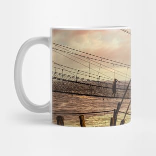 A man on a swinging rope foot bridge. Mug